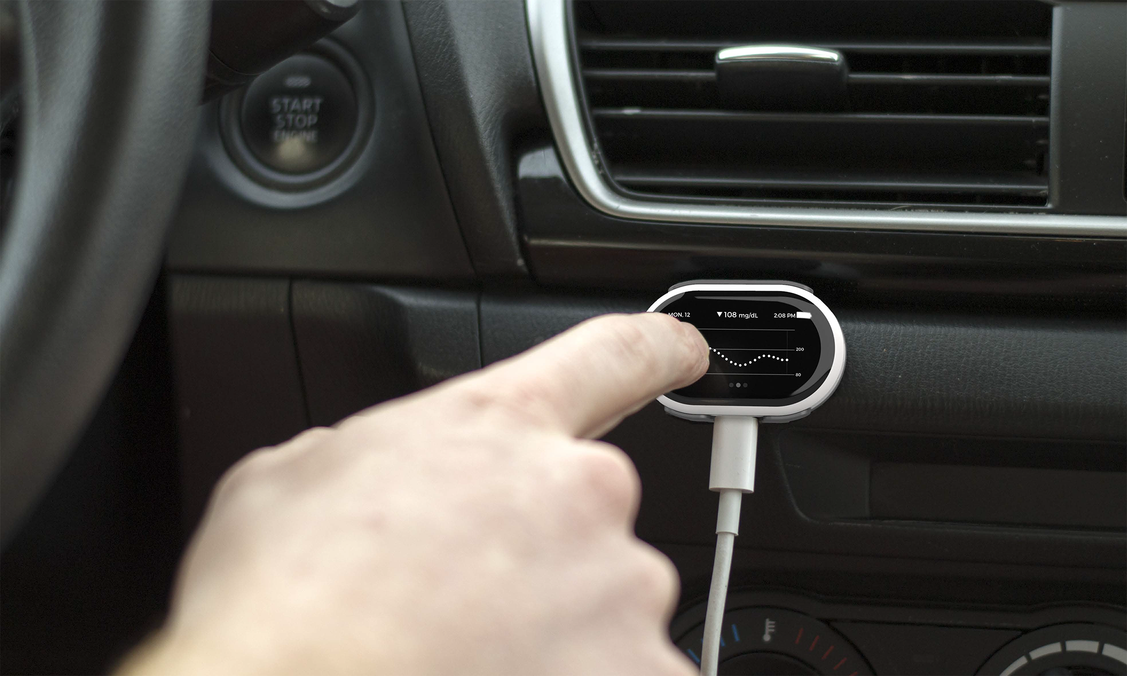 A rendering of the receiver mounted on the dashboard of a car as someone points to it.